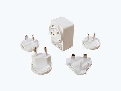 Set of white travel adapters on a white background